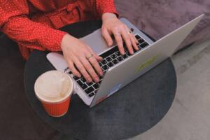 Laptop and coffee on a desk for reading business blogs